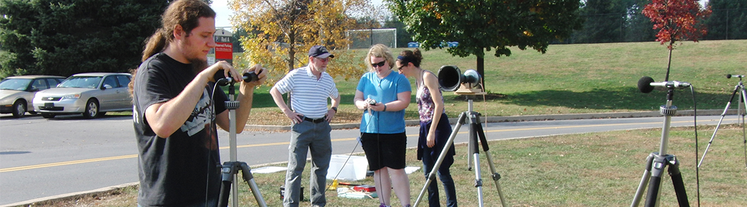 Students setup mics and take outdoor noise measurements. 
